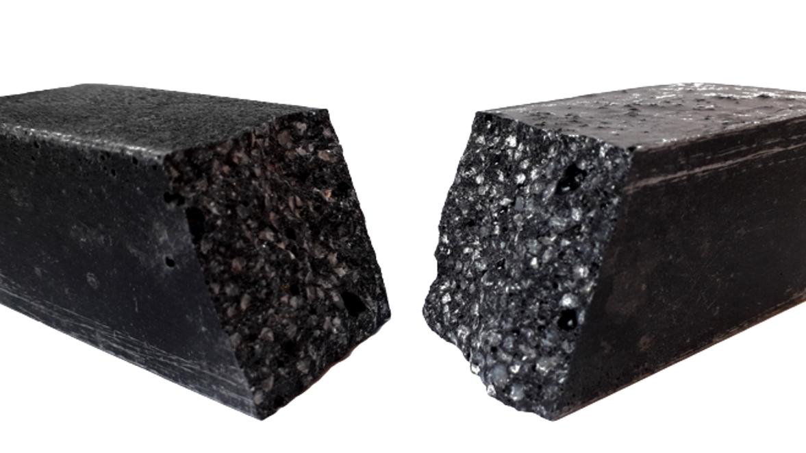 Ein Stück schwarzer Polymerbeton, der in der Mitte auseinander gebrochen ist